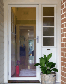 Amplimesh SupaScreen installed in a security screen door. The door is looking into a house.